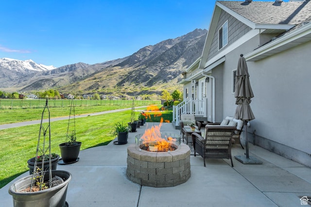 view of patio featuring a mountain view and an outdoor fire pit