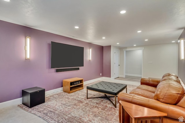 living room featuring recessed lighting, baseboards, and light colored carpet