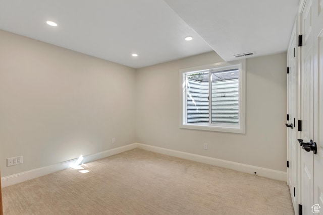empty room featuring visible vents, recessed lighting, baseboards, and light colored carpet