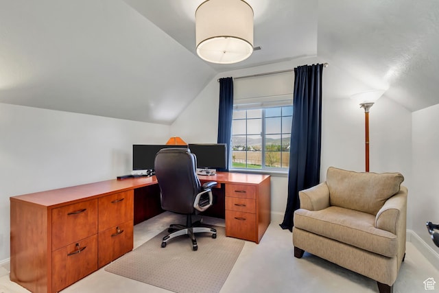 office with light colored carpet, baseboards, and vaulted ceiling