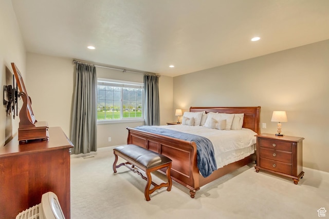 bedroom with baseboards, recessed lighting, and light colored carpet