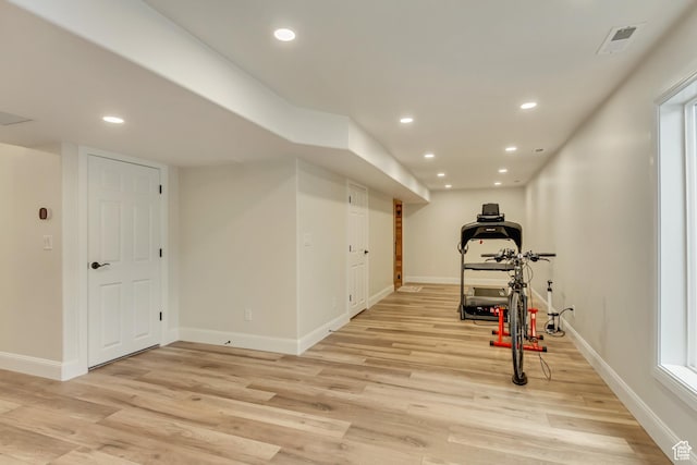 exercise room featuring visible vents, recessed lighting, light wood-style flooring, and baseboards