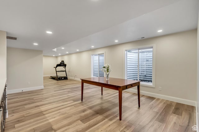 office space featuring light wood-type flooring, recessed lighting, baseboards, and visible vents