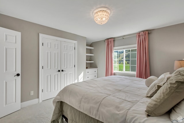 bedroom featuring a closet, carpet flooring, and baseboards