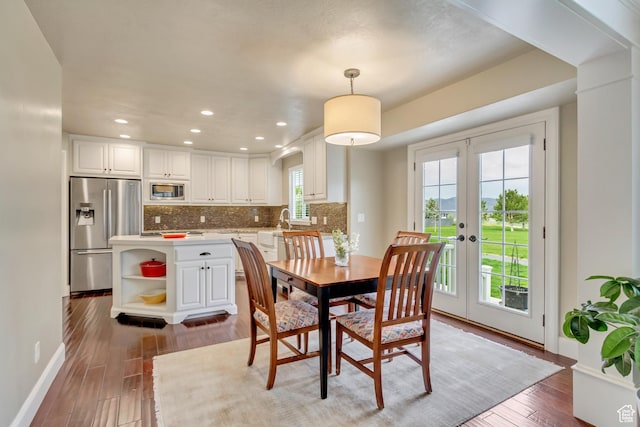 dining space with baseboards, french doors, recessed lighting, and wood finished floors