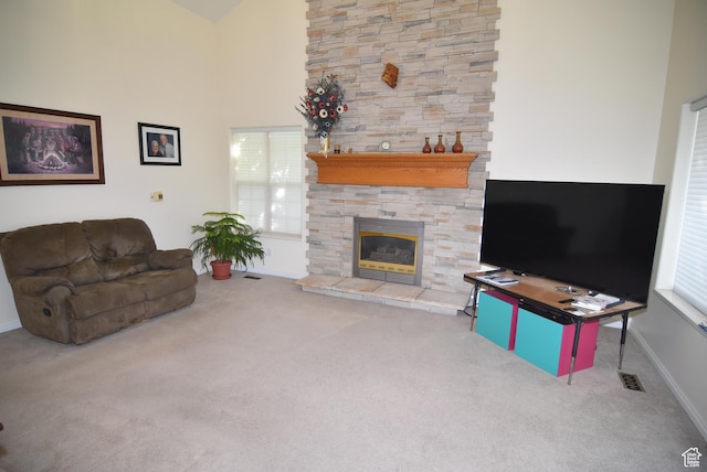 183 E Ama Fille Ln N, Elk Ridge, UT 84651 - living room featuring carpet, a stone fireplace, baseboards, and a towering ceiling