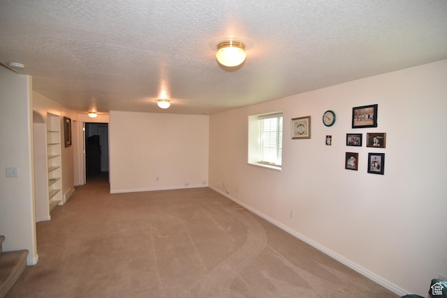 183 E Ama Fille Ln N, Elk Ridge, UT 84651 - unfurnished room with a textured ceiling, light colored carpet, baseboards, built in shelves, and a smoke detector