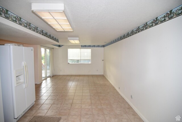 183 E Ama Fille Ln N, Elk Ridge, UT 84651 - unfurnished room with a textured ceiling, light tile patterned floors, and baseboards