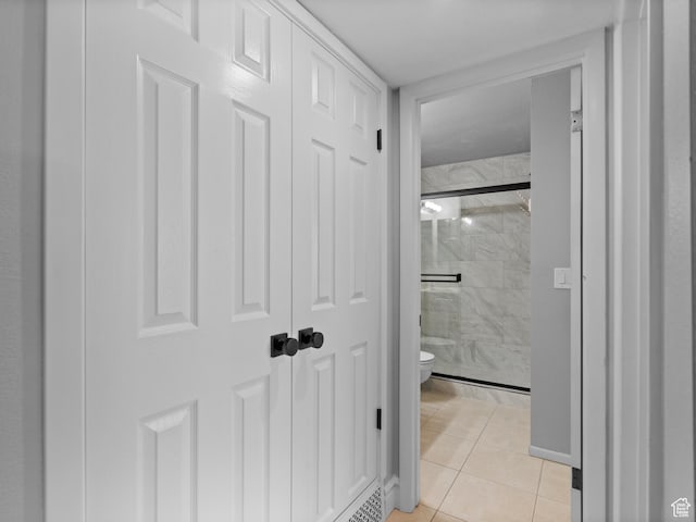 corridor featuring light tile patterned floors