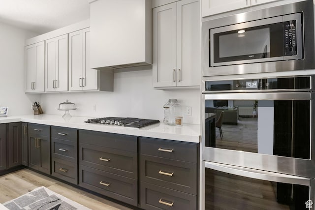 423 W Red Wolf Dr, Saratoga Springs, UT 84045 - kitchen featuring appliances with stainless steel finishes, light countertops, white cabinets, light wood-type flooring, and gray cabinets