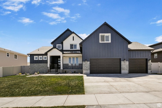 423 W Red Wolf Dr, Saratoga Springs, UT 84045 - view of front facade with board and batten siding, a front yard, driveway, and fence
