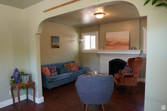 738 S Gudgell Ct, Salt Lake City, UT 84111 - living area featuring a textured ceiling, baseboards, wood-type flooring, arched walkways, and a fireplace
