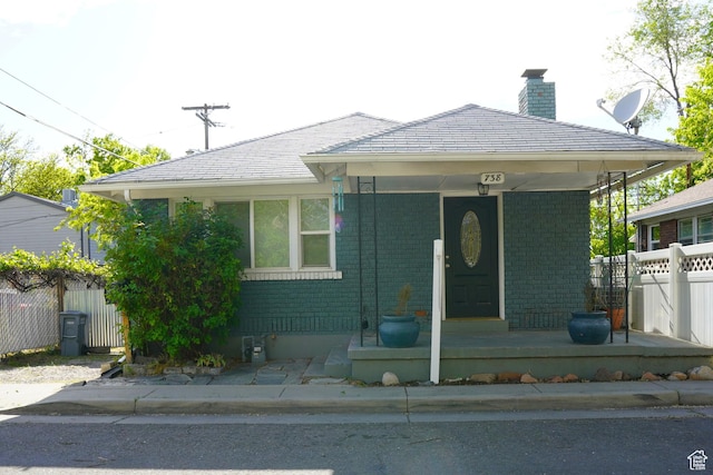 738 S Gudgell Ct, Salt Lake City, UT 84111 - bungalow-style home featuring covered porch, brick siding, a chimney, and fence