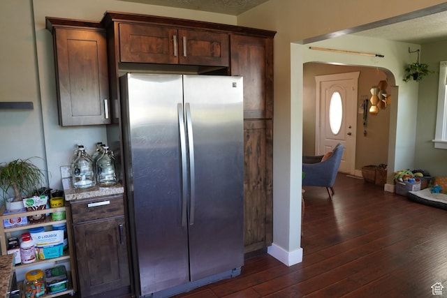 738 S Gudgell Ct, Salt Lake City, UT 84111 - kitchen with dark brown cabinets, freestanding refrigerator, dark wood-type flooring, baseboards, and arched walkways