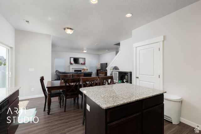 2034 E 970 N, Spanish Fork, UT 84660 - kitchen featuring a fireplace, baseboards, dark wood-style flooring, a kitchen island, and recessed lighting