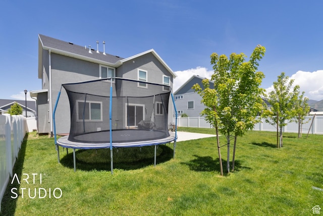 2034 E 970 N, Spanish Fork, UT 84660 - rear view of house featuring a trampoline and stucco siding