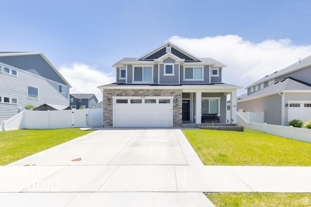 2034 E 970 N, Spanish Fork, UT 84660 - craftsman-style house with covered porch, an attached garage, concrete driveway, stone siding, and a gate