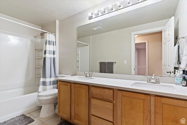 bathroom featuring toilet, tile patterned flooring, visible vents, and a sink