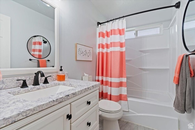 bathroom featuring vanity, toilet, shower / tub combo, and wood finished floors