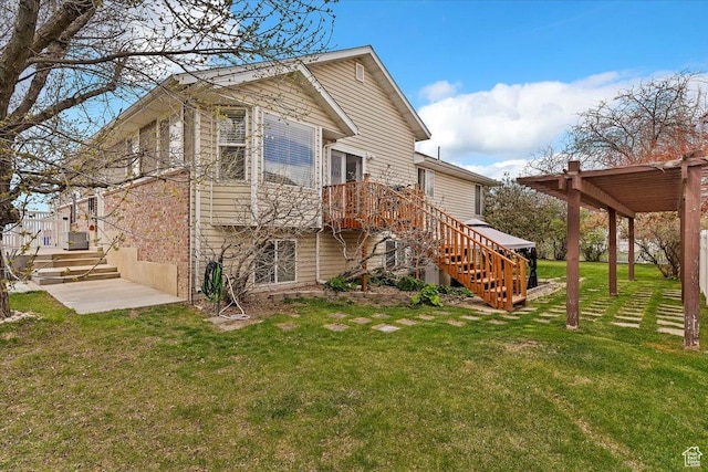 exterior space featuring a lawn, stairs, and a deck