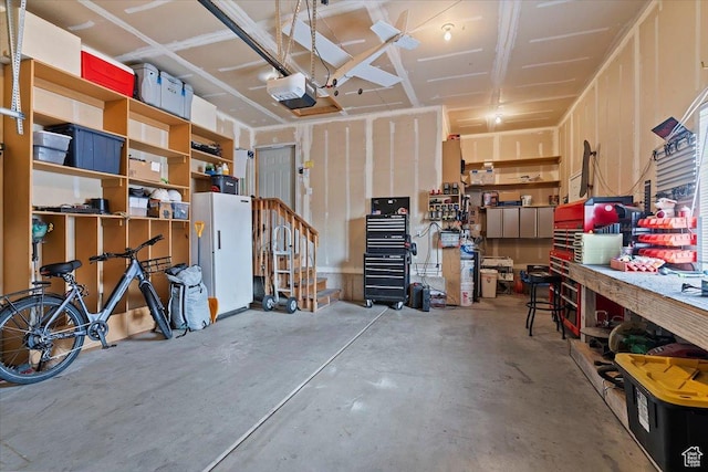 garage featuring a workshop area and a garage door opener