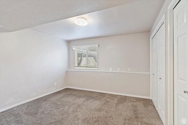 unfurnished bedroom with a closet, baseboards, and carpet floors