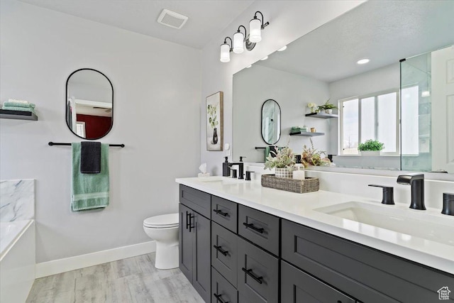 full bathroom with toilet, visible vents, baseboards, and a sink