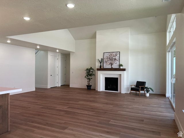 1148 N 1875 E Unit 2, Layton, UT 84040 - unfurnished living room featuring wood finished floors, a fireplace, recessed lighting, a textured ceiling, and high vaulted ceiling