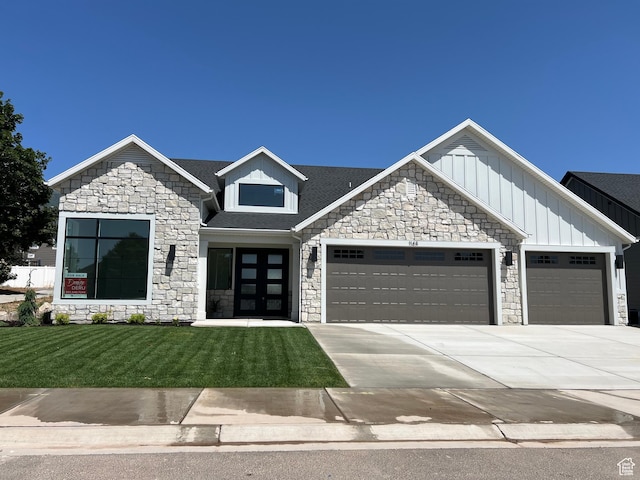1148 N 1875 E Unit 2, Layton, UT 84040 - view of front of home featuring stone siding, a garage, a front lawn, concrete driveway, and board and batten siding