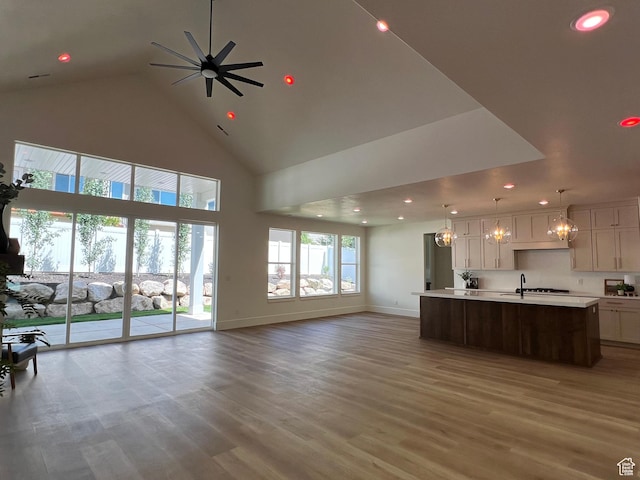 1148 N 1875 E Unit 2, Layton, UT 84040 - unfurnished living room with high vaulted ceiling, recessed lighting, light wood-type flooring, ceiling fan, and a chandelier