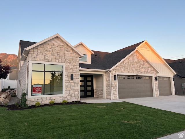 1148 N 1875 E Unit 2, Layton, UT 84040 - view of front of house with stone siding, an attached garage, a front yard, board and batten siding, and concrete driveway