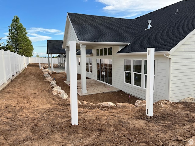 1148 N 1875 E Unit 2, Layton, UT 84040 - back of property with a shingled roof and a patio area