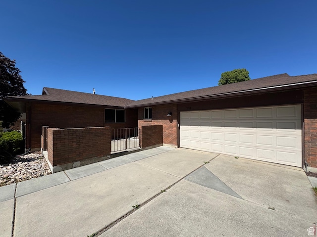 281 N Pin Oak Cir, Kaysville, UT 84037 - ranch-style house featuring concrete driveway, brick siding, fence, and a garage