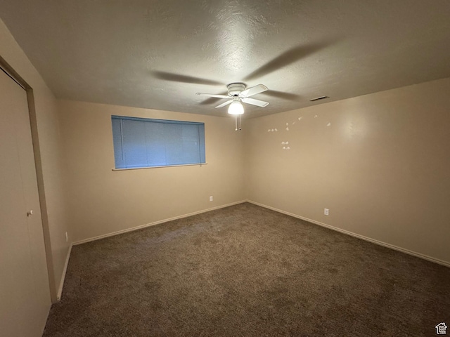 281 N Pin Oak Cir, Kaysville, UT 84037 - spare room featuring baseboards, dark carpet, ceiling fan, and a textured ceiling