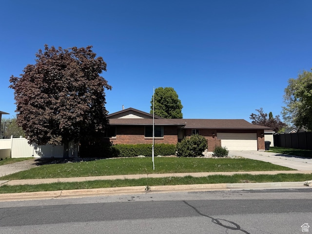281 N Pin Oak Cir, Kaysville, UT 84037 - view of front of property featuring driveway, brick siding, a garage, and fence