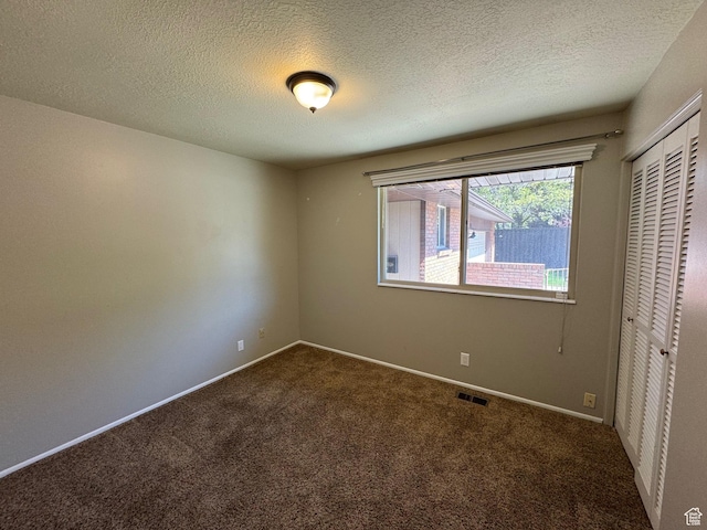 281 N Pin Oak Cir, Kaysville, UT 84037 - unfurnished room with a textured ceiling, visible vents, baseboards, and dark colored carpet