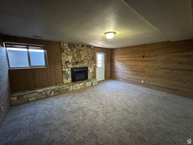 281 N Pin Oak Cir, Kaysville, UT 84037 - unfurnished living room with a fireplace, wooden walls, and a textured ceiling
