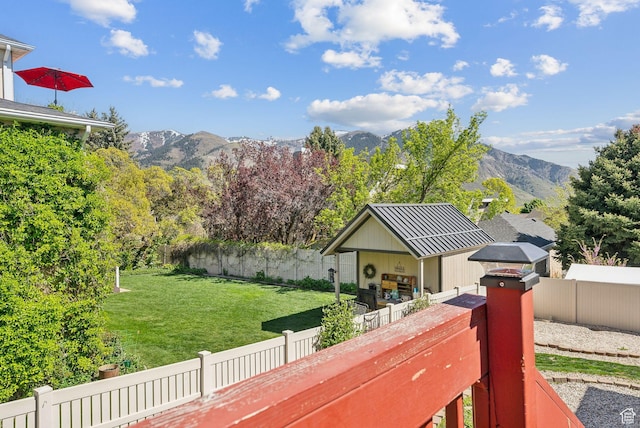 exterior space featuring a yard, a mountain view, and a fenced backyard