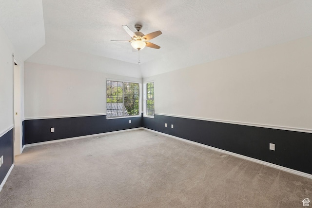 unfurnished room with a ceiling fan, baseboards, carpet, and lofted ceiling