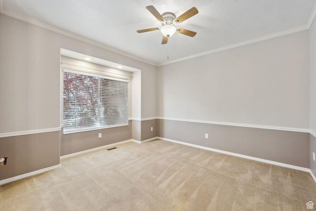 unfurnished room featuring carpet flooring, crown molding, and ceiling fan
