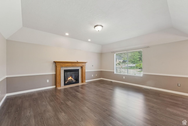 unfurnished living room with recessed lighting, baseboards, a fireplace with flush hearth, and wood finished floors