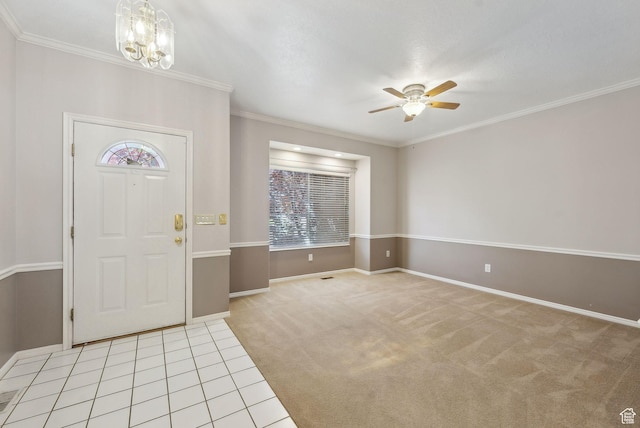 entryway with baseboards, a healthy amount of sunlight, light colored carpet, and ceiling fan with notable chandelier