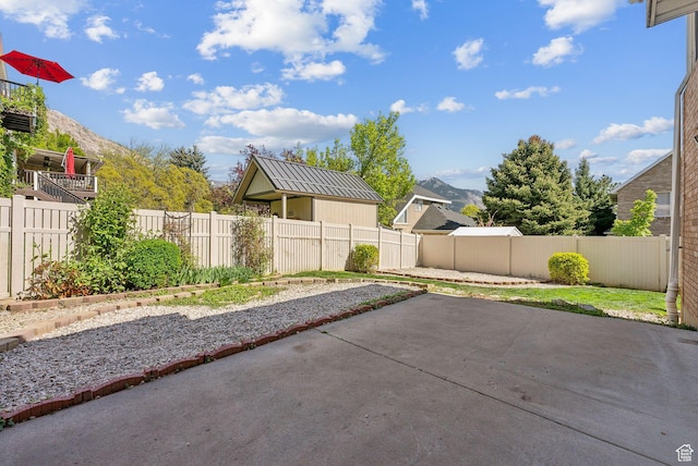 view of patio / terrace with a fenced backyard and a mountain view