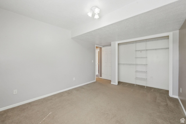 unfurnished bedroom with carpet floors, baseboards, and a closet