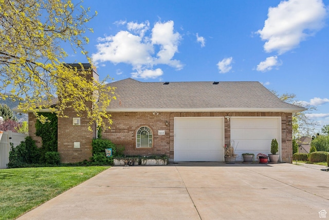 view of front of property featuring brick siding, a garage, a shingled roof, concrete driveway, and a front lawn