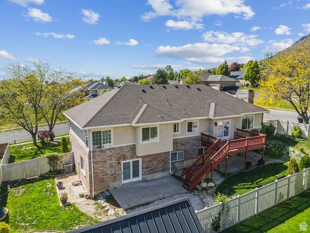 back of property featuring roof with shingles, a patio area, stucco siding, a fenced backyard, and a wooden deck