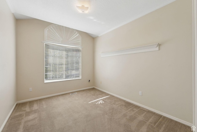 carpeted spare room featuring baseboards