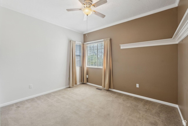 empty room featuring ceiling fan, light colored carpet, and baseboards