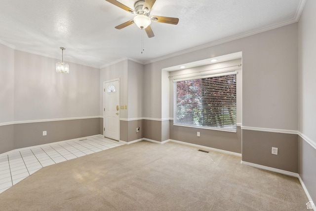 unfurnished room featuring baseboards, tile patterned floors, crown molding, and ceiling fan with notable chandelier