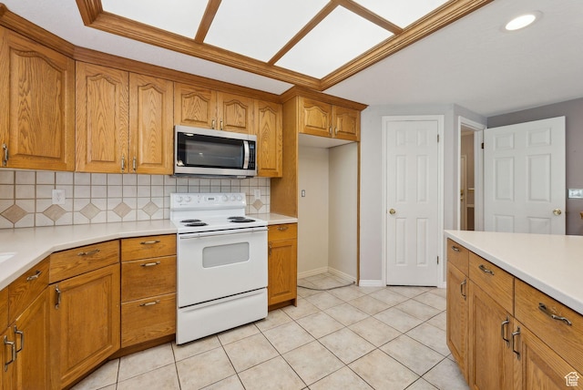 kitchen with brown cabinets, stainless steel microwave, and electric range